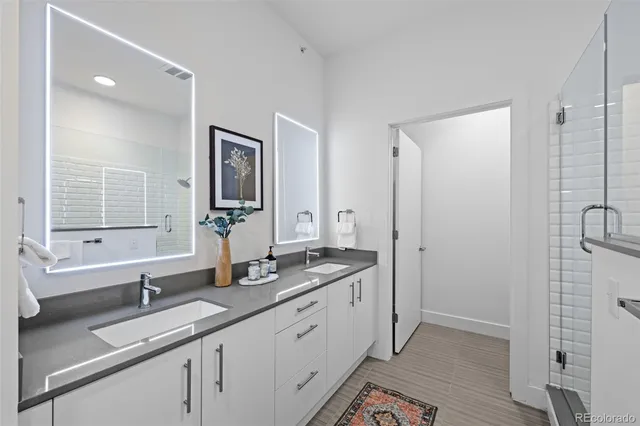 a bathroom with a granite countertop sink mirror and double