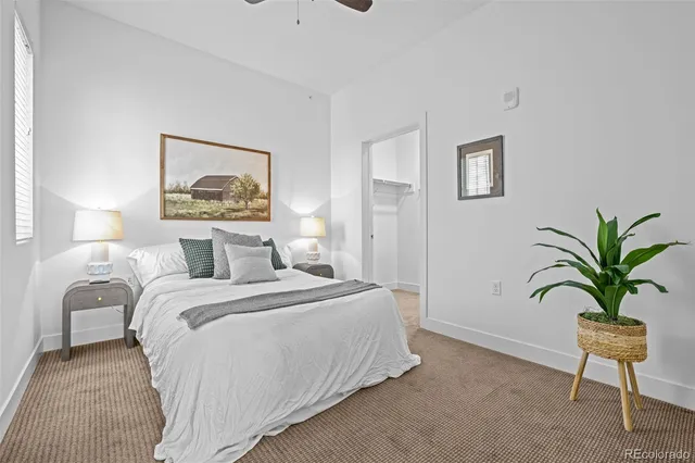 a bedroom with a bed and a painting on the wall