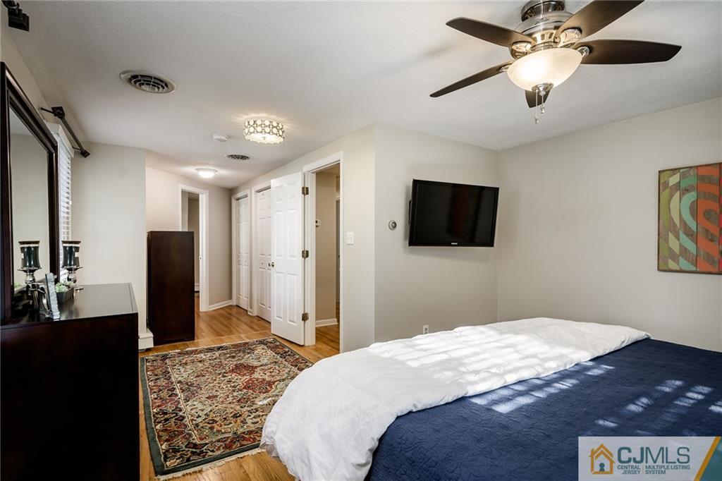 16 Ryan Road Cranbury, NJ 08512 - Photo 11 of 24 a bedroom with a bed and a flat screen tv