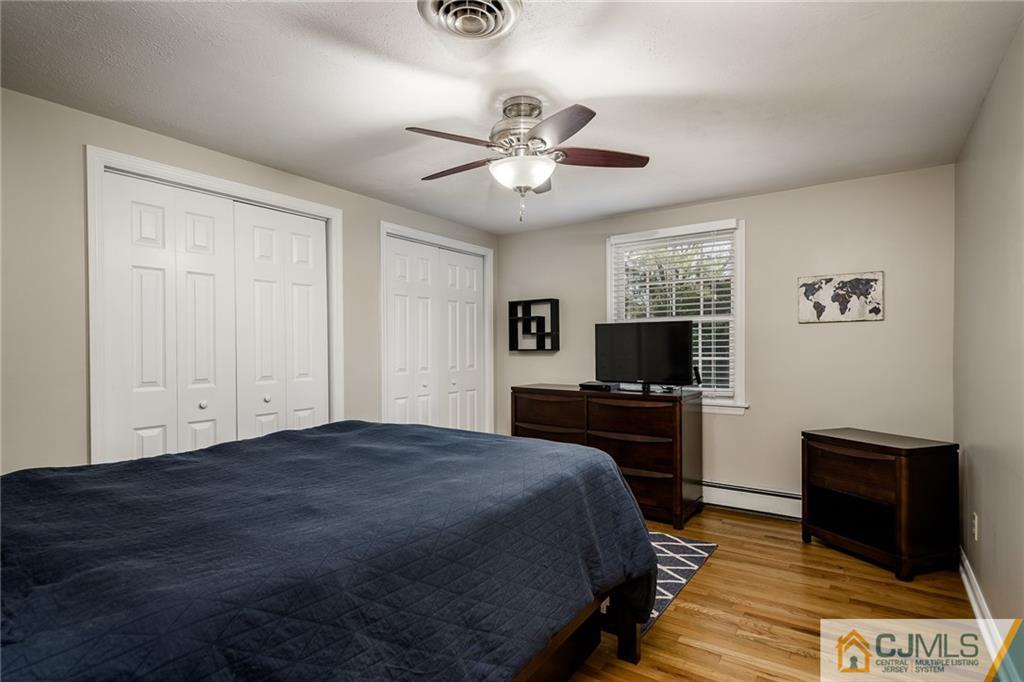 16 Ryan Road Cranbury, NJ 08512 - Photo 13 of 24 a bedroom with a bed and a flat screen tv