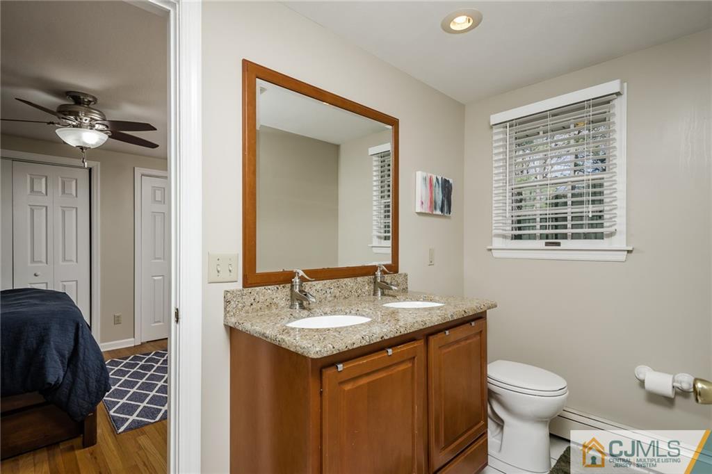 16 Ryan Road Cranbury, NJ 08512 - Photo 15 of 24 a bathroom with a toilet a sink and a mirror