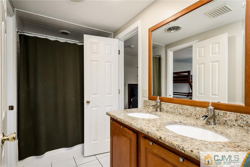 16 Ryan Road Cranbury, NJ 08512 - Photo 16 of 24 a bathroom with a granite countertop sink and a mirror