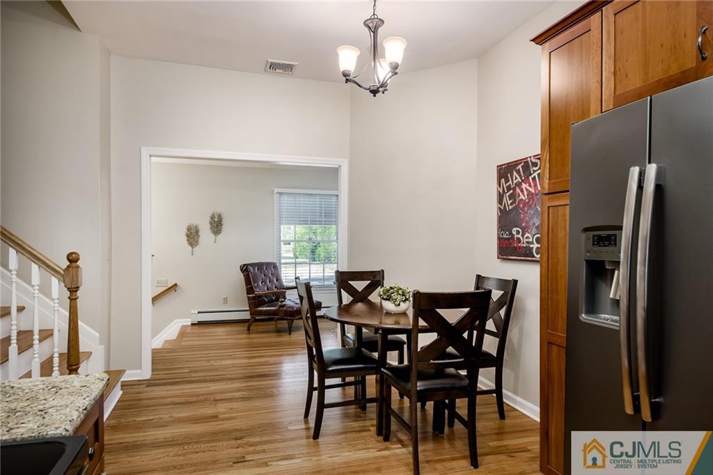 16 Ryan Road Cranbury, NJ 08512 - Photo 4 of 24 a view of a dining room with furniture and wooden floor