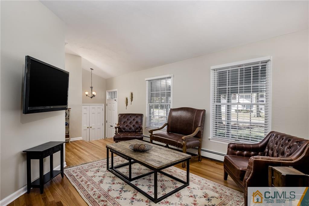 16 Ryan Road Cranbury, NJ 08512 - Photo 6 of 24 a living room with furniture and a flat screen tv