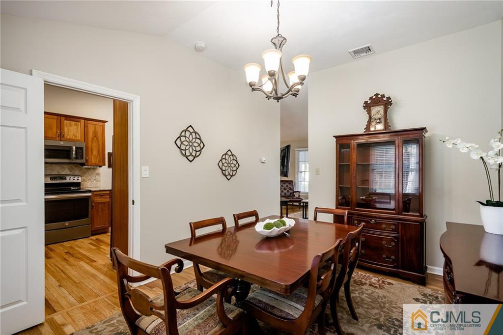 16 Ryan Road Cranbury, NJ 08512 - Photo 7 of 24 a view of a dining room with furniture wooden floor and a chandelier