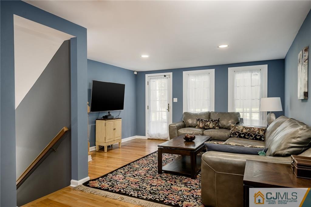 16 Ryan Road Cranbury, NJ 08512 - Photo 9 of 24 a living room with furniture and a flat screen tv