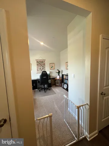 a view of a livingroom with workspace and a couch