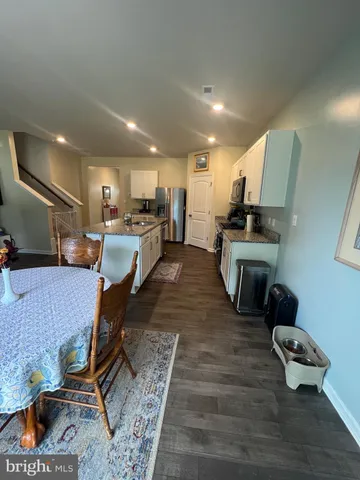 a spacious bathroom with a granite countertop sink and a large mirror