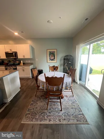 a view of a hallway with stairs and wooden floor
