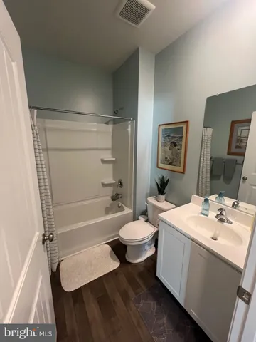 a bathroom with a sink a toilet a mirror and vanity