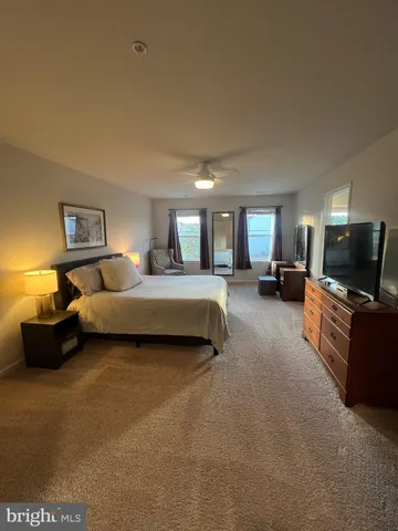 a bedroom with furniture and a wooden floor