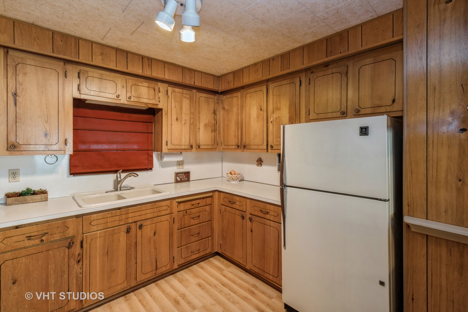1096 Lake Terrace Road Elgin, IL 60123 - Photo 8 of 25 a kitchen with a sink a refrigerator and cabinets