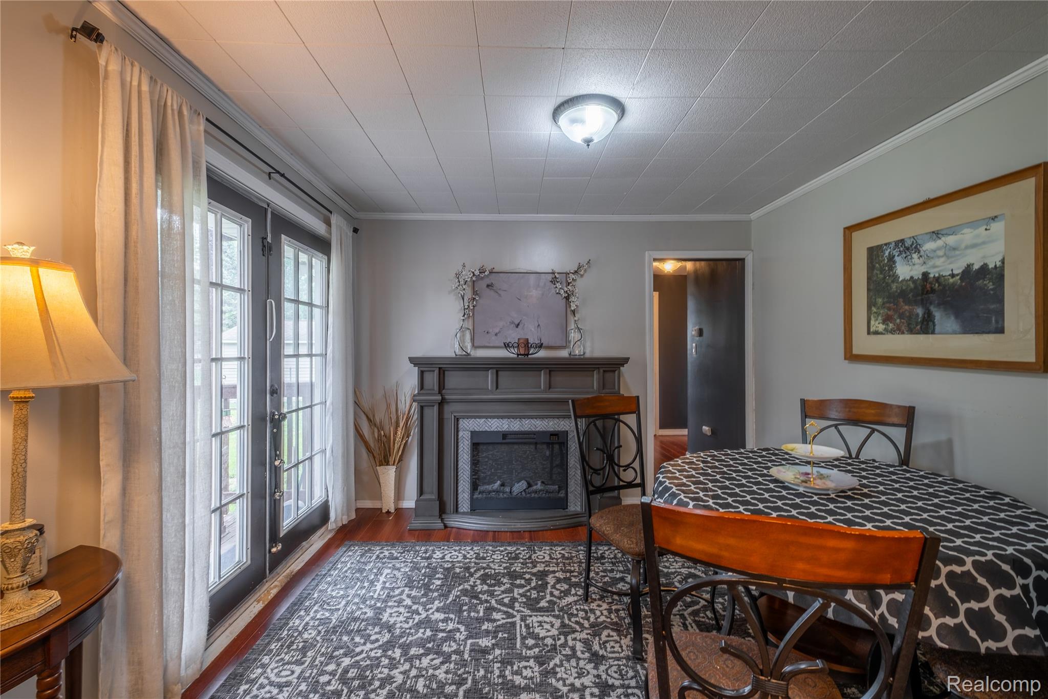 7800 Maple Street Birch Run, MI 48415 - Photo 5 of 29 Interior space featuring a decorative fireplace with a substantial mantel, wood-finish flooring, and light gray wall paint