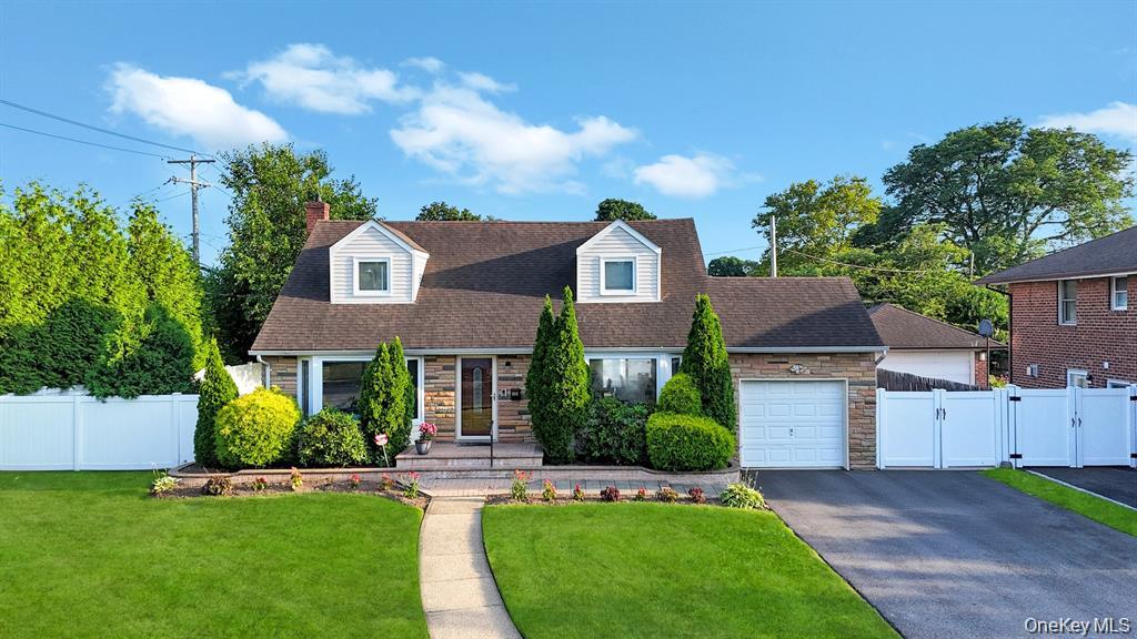 a front view of a house with a garden and plants
