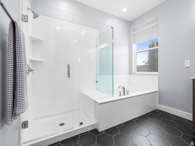 877 South Yarrow Drive Mapleton, UT 84664 - Photo 12 of 46 Bathroom featuring a walk-in shower with glass enclosure, separate soaking tub, and dark hexagon tile flooring