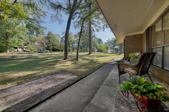 a view of a yard with wooden fence
