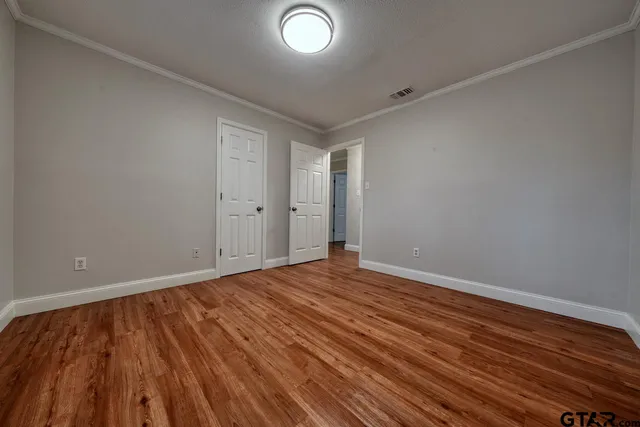a view of an empty room and wooden floor