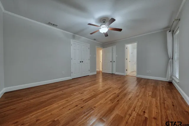 a view of an empty room with wooden floor