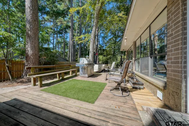 a view of a chairs and table on the wooden deck