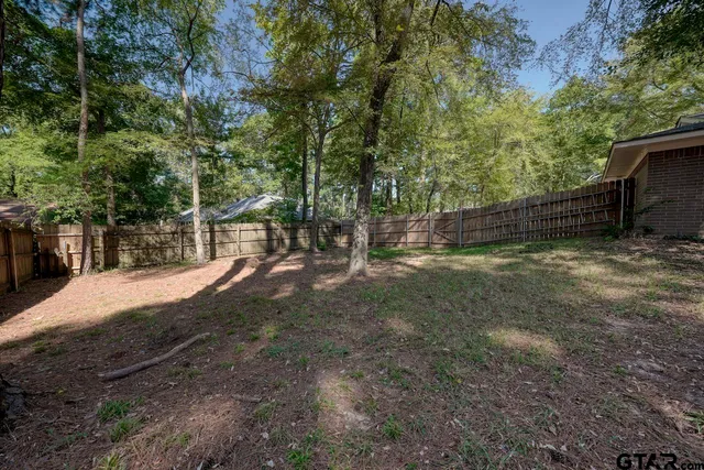 a view of a field with trees in the background