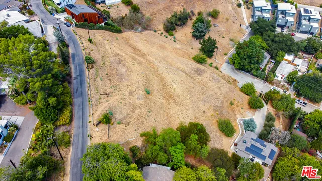 an aerial view of a house with a yard and garden