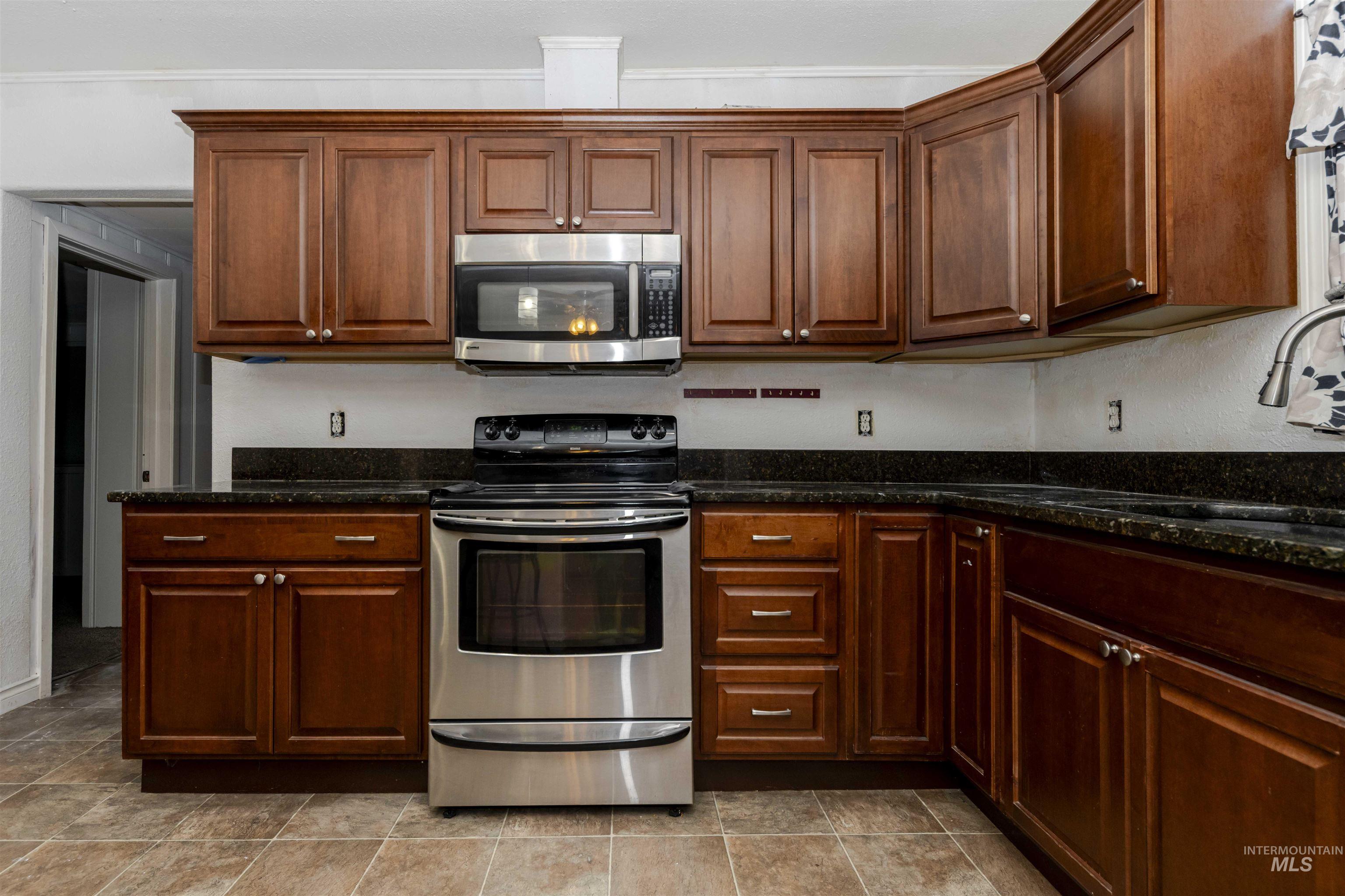 1906 15th Avenue Lewiston, ID 83501 - Photo 2 of 18 Kitchen with stainless steel appliances and dark stone counters