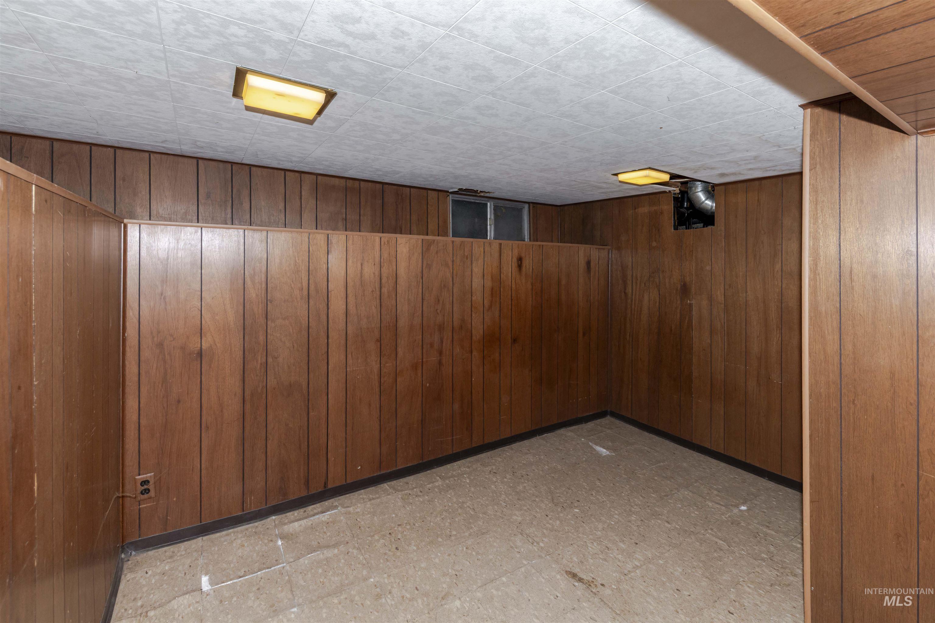 1906 15th Avenue Lewiston, ID 83501 - Photo 8 of 18 Finished below grade area featuring tile patterned floors and wood walls