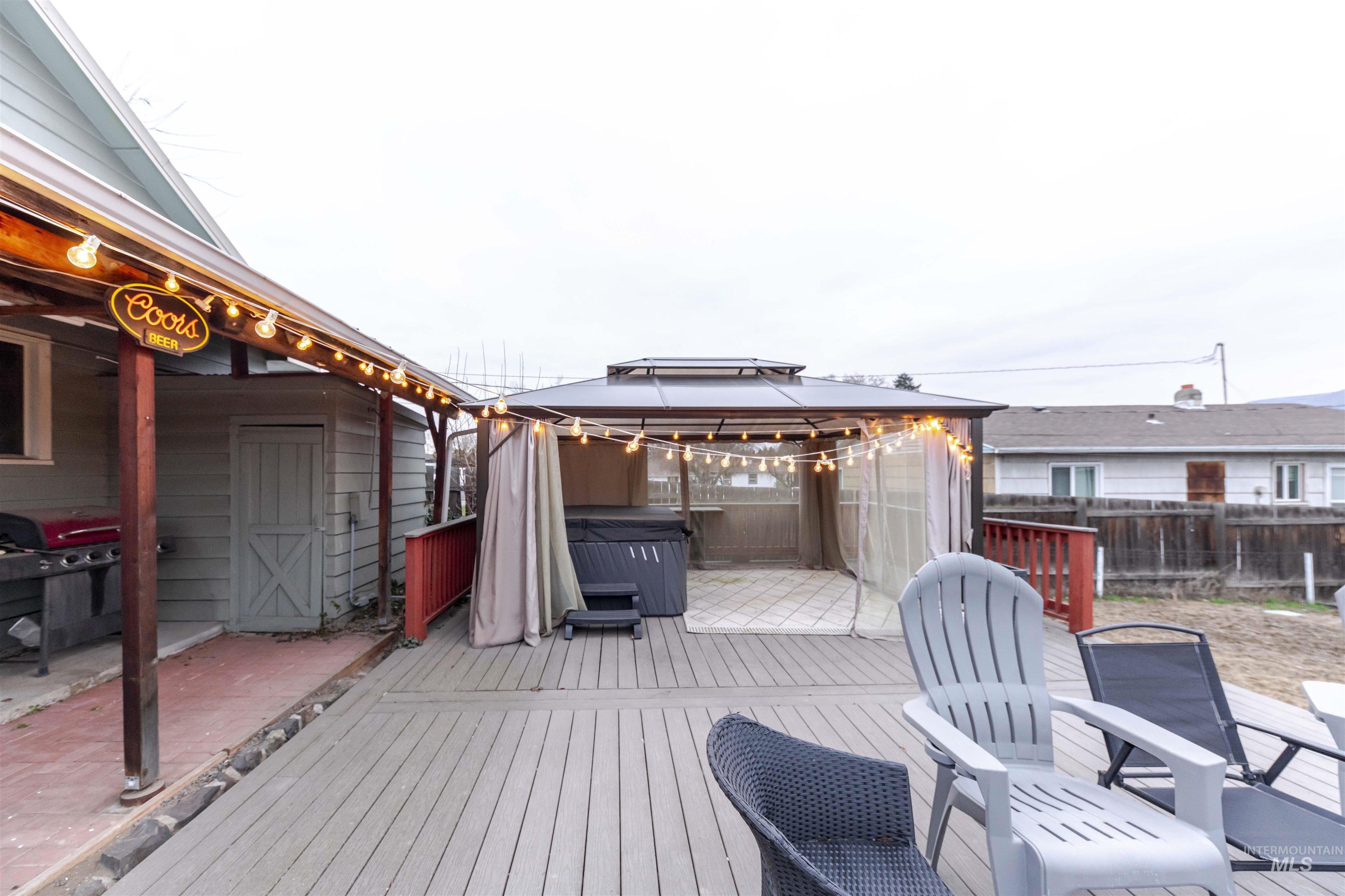 1906 15th Avenue Lewiston, ID 83501 - Photo 9 of 18 Wooden deck with a gazebo, a fenced backyard, a grill, and a hot tub
