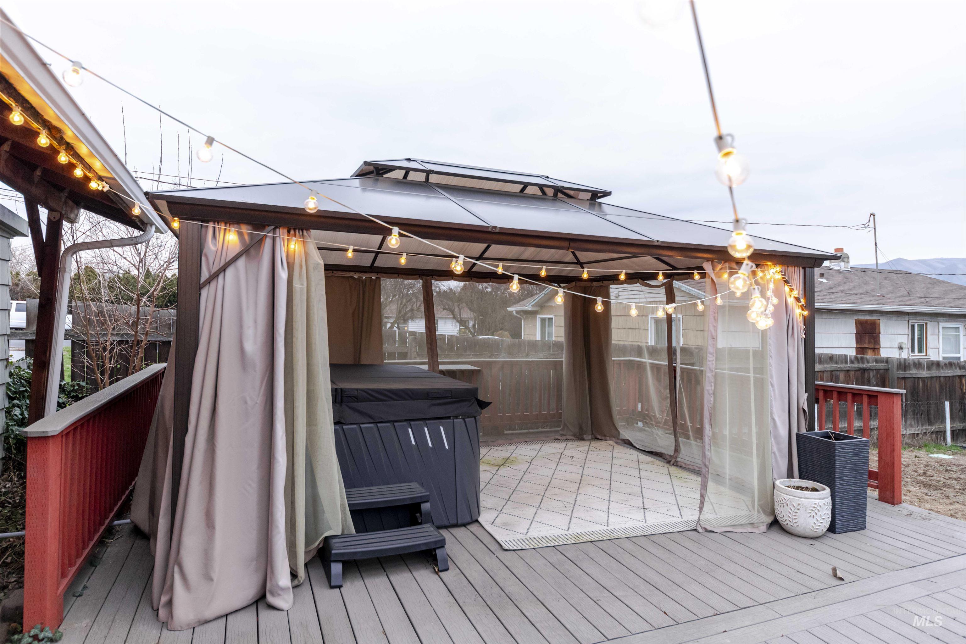 1906 15th Avenue Lewiston, ID 83501 - Photo 10 of 18 Wooden terrace featuring a gazebo, a fenced backyard, and a hot tub
