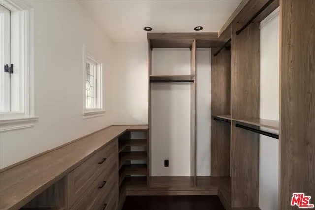 a bathroom with a sink double vanity granite tub shower and a mirror