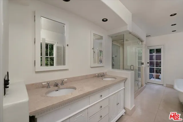 a spacious bathroom with a bathtub and shower