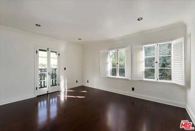 a view of wooden floor and windows in a room