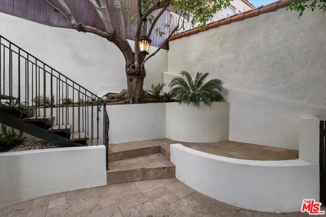 a view of a pathway in back yard of a house