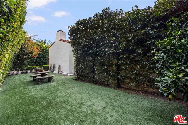 a view of a bench in backyard of the house