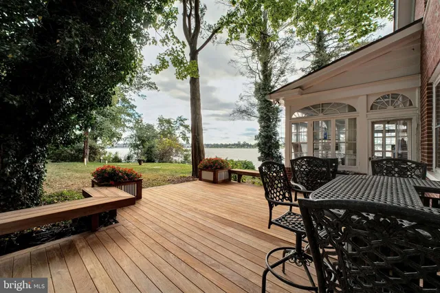 a living room with furniture large window and wooden floor
