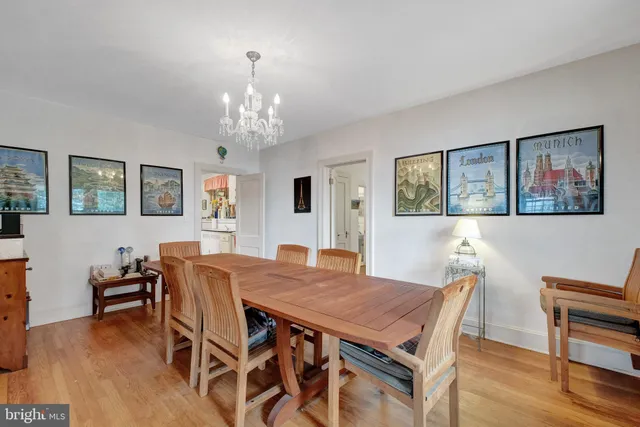 a dining room with stainless steel appliances granite countertop a sink and a large window