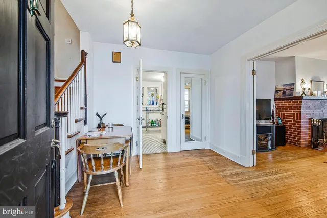 a view of a dining room with furniture and chandelier