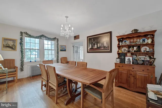 a dining room with furniture and a floor to ceiling window