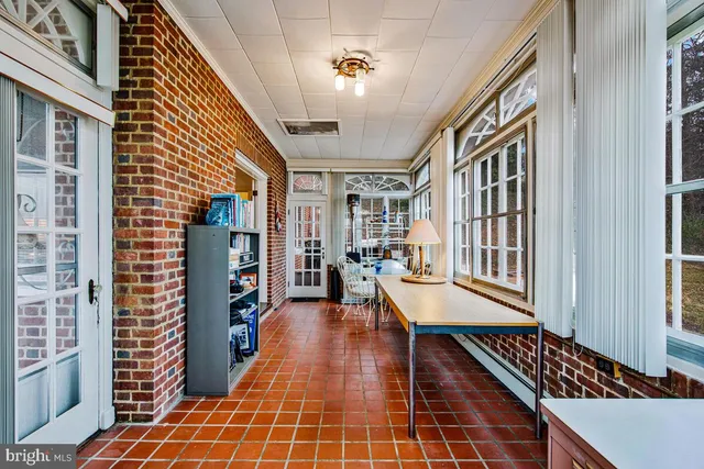 a view of a hall with wooden floor