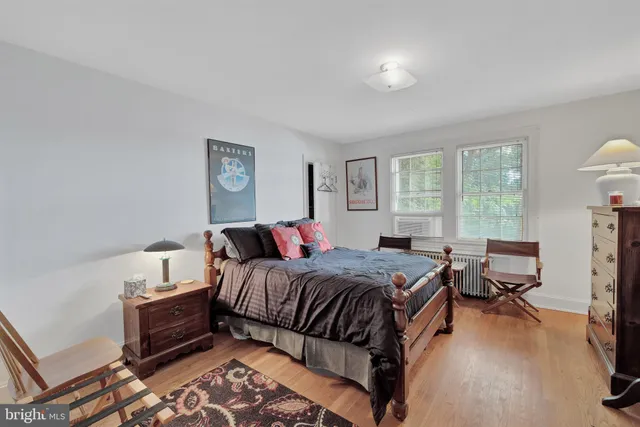 a view of a room with wooden floor and a bathroom