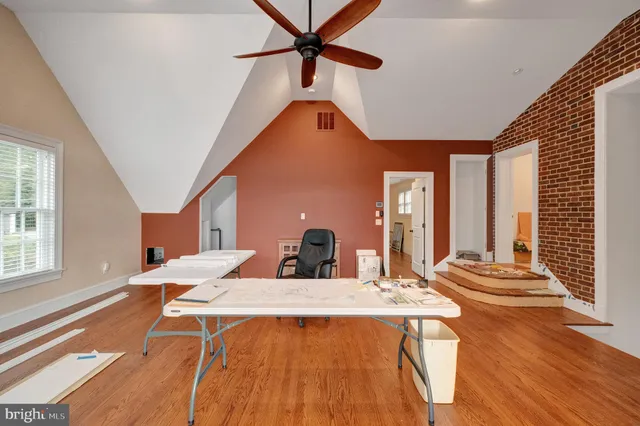 a view of staircase with white walls and white door