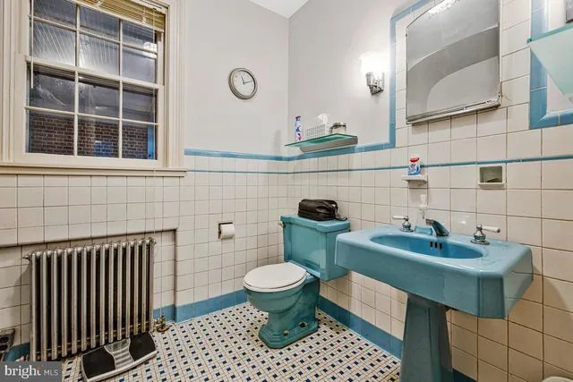 a view of staircase with white walls and white door