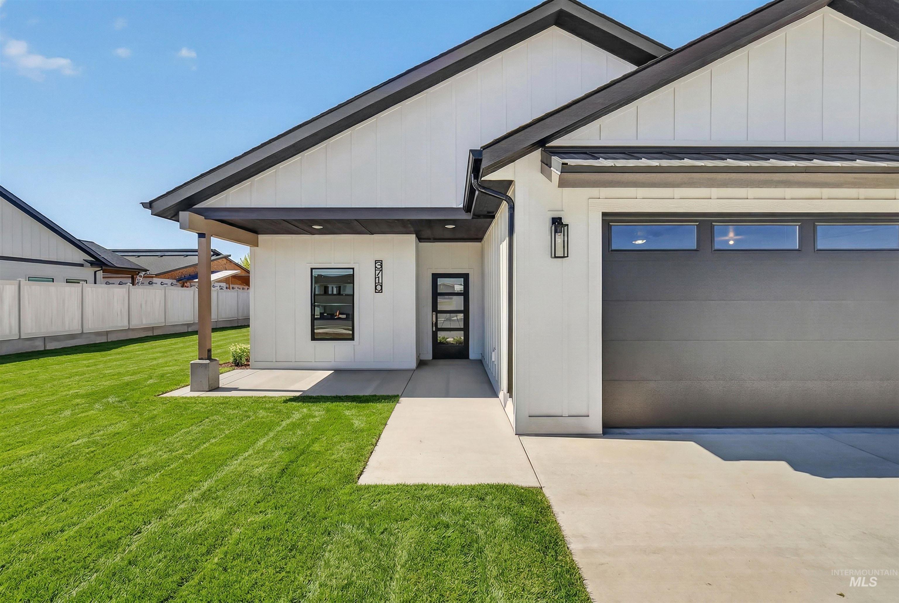 3710 22nd Street Lewiston, ID 83501 - Photo 2 of 36 Modern farmhouse featuring a garage, a standing seam roof, driveway, and board and batten siding