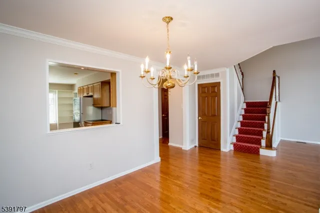a view of a room with wooden floor and workspace