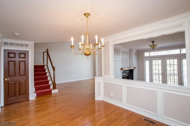 a view of a room with wooden floor and stairs