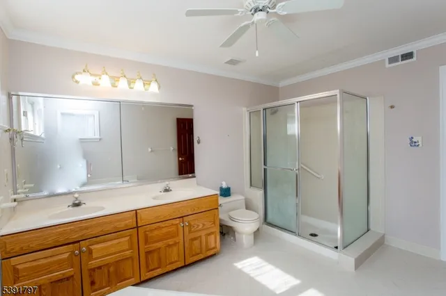 a spacious bathroom with a double vanity sink mirror and double