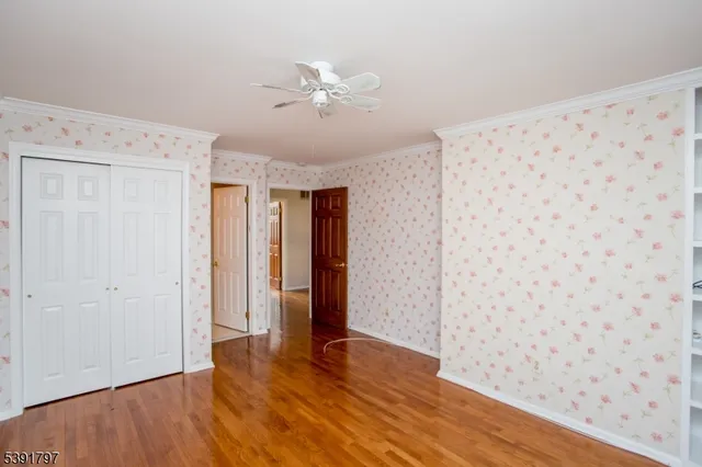 a view of a room with wooden floor and closet