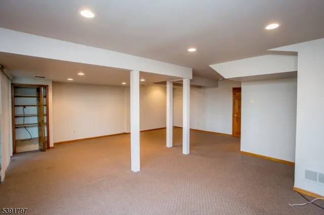 an empty room with closet and natural light