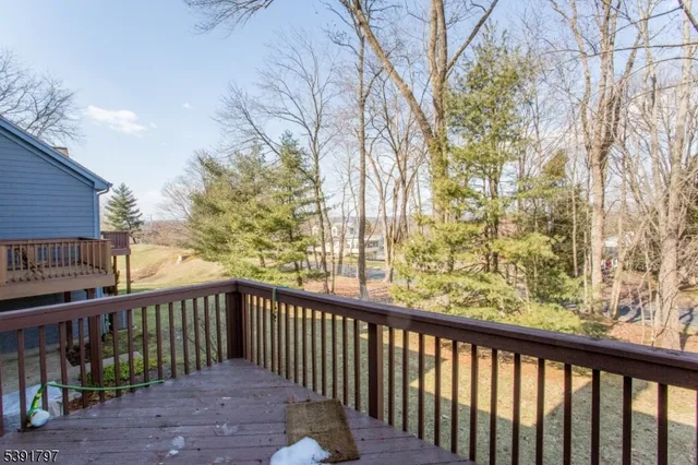 a view of a balcony with wooden fence and floor
