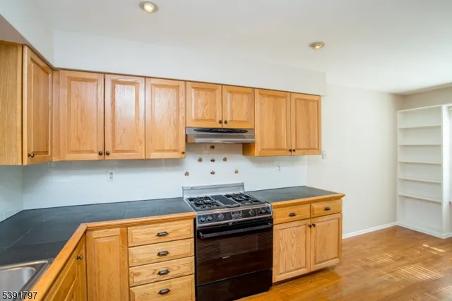 a kitchen with stainless steel appliances granite countertop a stove and a refrigerator